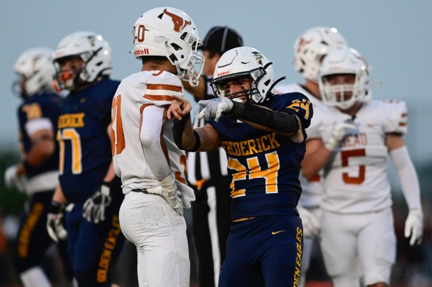 Frederick’s Sonny Delpizzo, center, celebrates a first down against Mead...
