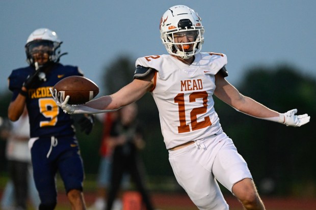 Mead’s Eli Davis, right, runs in for a touchdown against...
