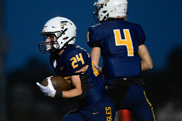 Frederick’s Sonny Delpizzo, left, runs the ball against Mead on...