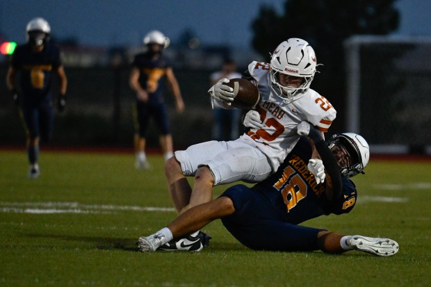 Mead’s Breckan Palko, left, is brought down by Frederick’s Marllow...