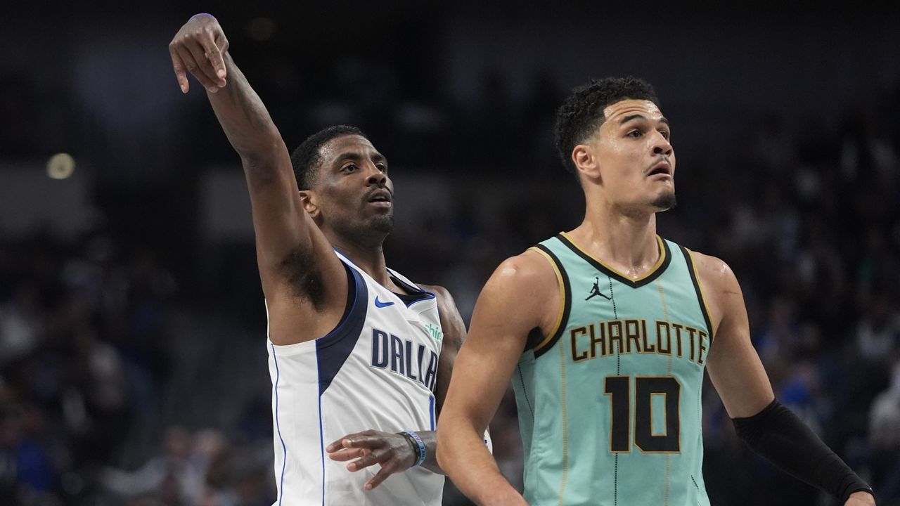 Dallas Mavericks guard Kyrie Irving (11) watches his shot against Charlotte Hornets guard Josh Green (10) during the first half of an NBA basketball game in Dallas, Thursday, Feb. 27, 2025. (AP Photo/LM Otero)
