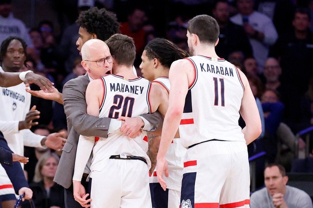  Dan Hurley head coach of the Connecticut Huskies celebrates with his team at the end of the second half. The Connecticut Huskies defeat the Villanova Wildcats 73-56 at Madison Square Garden in New York, New York, USA, Thursday, March 13, 2025. 