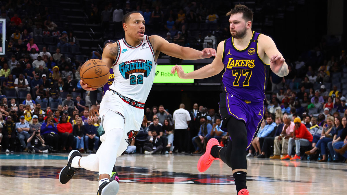 Memphis Grizzlies guard Desmond Bane (22) drives to the basket as Los Angeles Lakers guard Luka Doncic (77) defends during the fourth quarter at FedExForum.