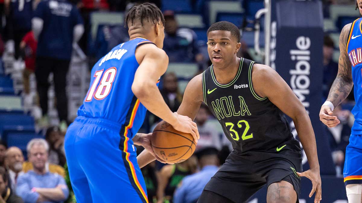 Oklahoma City Thunder forward Keyontae Johnson (18) dribbles against New Orleans Pelicans forward E.J. Liddell (32) during the second half at Smoothie King Center.