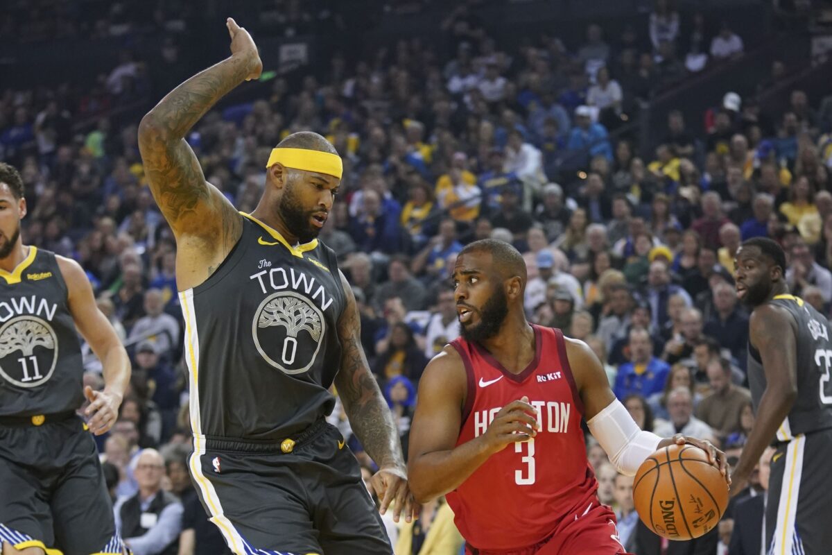 Houston Rockets guard Chris Paul (3) dribbles the basketball against Golden State Warriors center DeMarcus Cousins (0) during the first quarter at Oracle Arena.