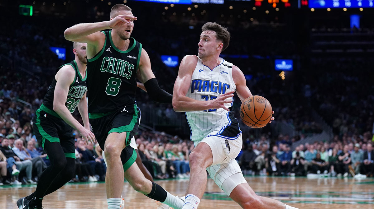 Orlando Magic forward Franz Wagner (22) drives the ball against Boston Celtics center Kristaps Porzingis (8) in the second quarter during game five of first round for the 2025 NBA Playoffs at TD Garden.
