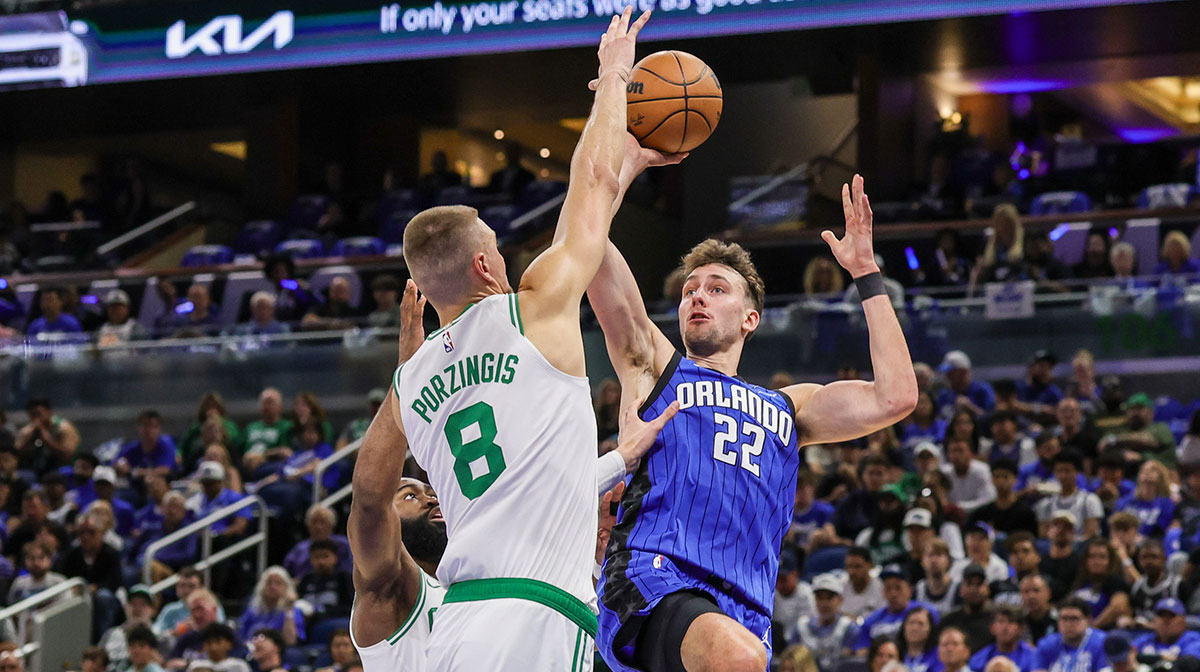 Orlando Magic forward Franz Wagner (22) shoots against Boston Celtics center Kristaps Porzingis (8) during the second quarter of game three of first round for the 2025 NBA Playoffs at Kia Center.