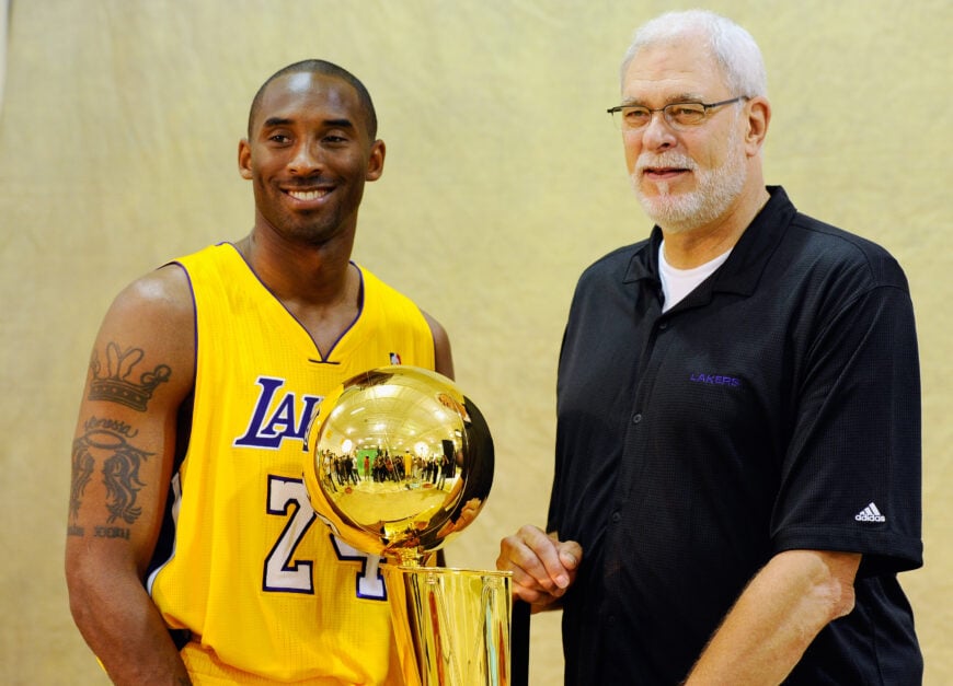 Kobe Bryant #24 and head coach Phil Jackson of the Los Angeles Lakers pose with NBA Finals Larry O'Brien Championship Trophy during Media Day at the Toyota Center on September 25, 2010 in El Segundo, California.