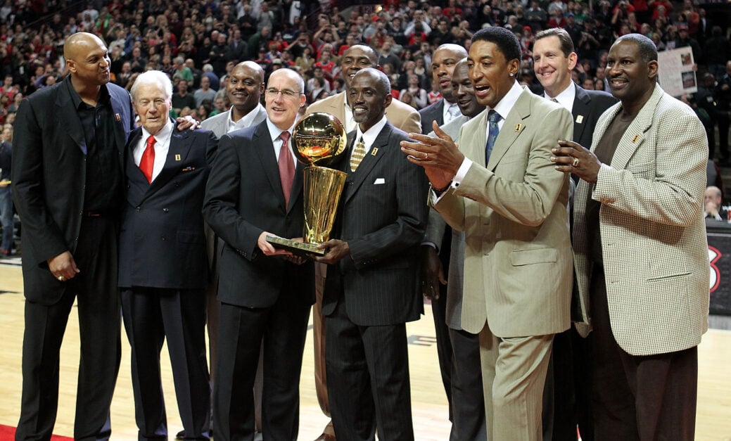 Former players Scott Williams, assistant coach Johnny Bach, Dennis Hopson, John Paxson, Horace Grant, Craig Hodges, Stacey King, Michael Jordan, Scottie Pippen, Will Purdue and Cliff Levingston of the Chicago Bulls pose with the trophy during a 20th anniversary recognition ceremony of the Bulls 1st NBA Championship