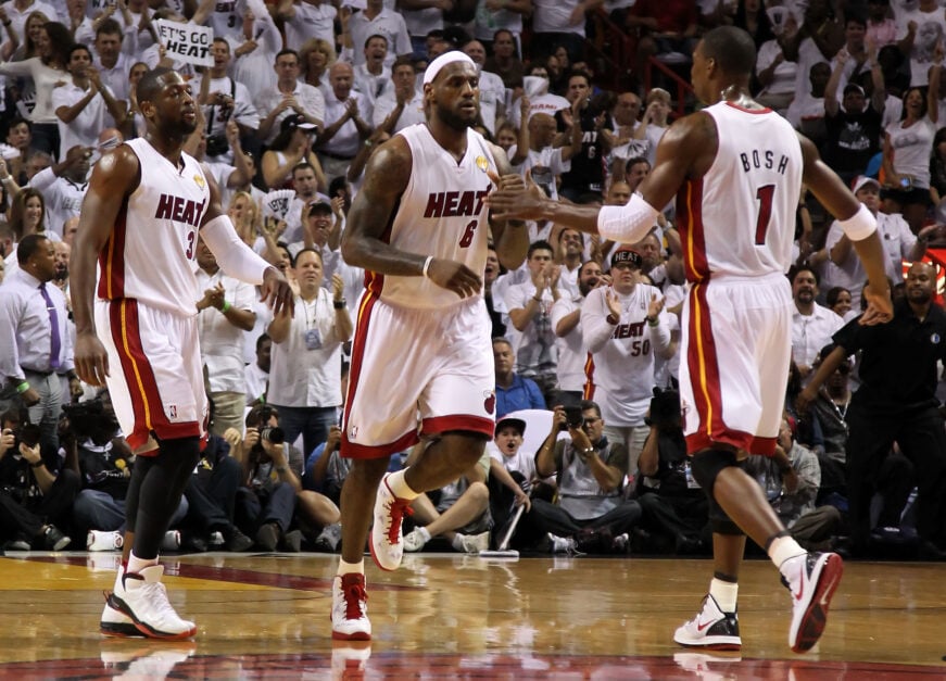 Dwyane Wade #3, LeBron James #6 and Chris Bosh #1 of the Miami Heat react on court against the Dallas Mavericks in Game Six of the 2011 NBA Finals at American Airlines Arena on June 12, 2011 in Miami, Florida.