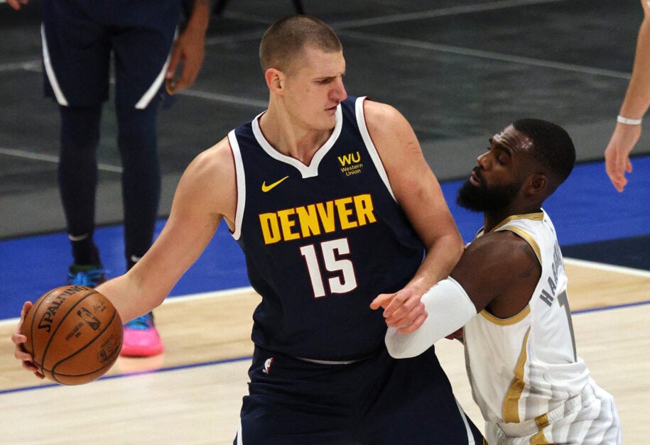 Nikola Jokic #15 of the Denver Nuggets dribbles the ball against Tim Hardaway Jr. #11 of the Dallas Mavericks in the first quarter at American Airlines Center on January 25, 2021 in Dallas, Texas.