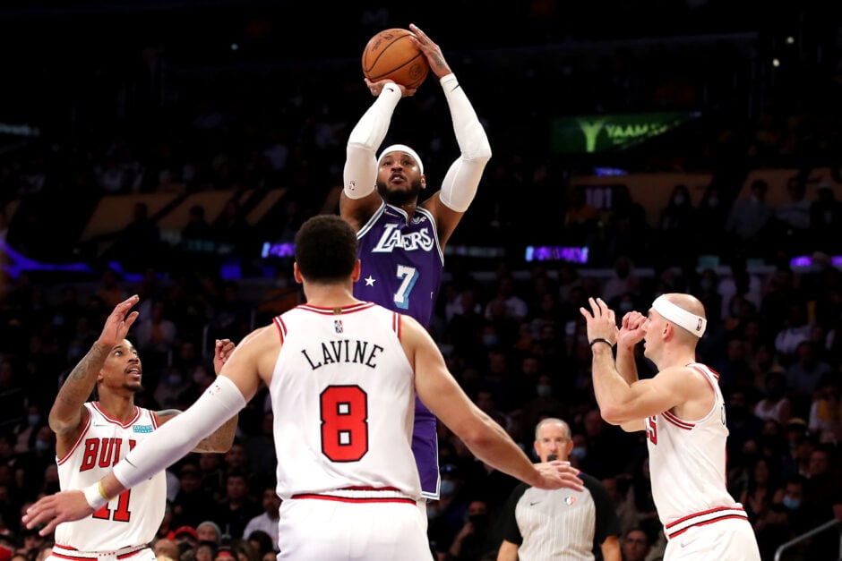 Carmelo Anthony #7 of the Los Angeles Lakers shoots a jump shot against Zach LaVine #8, DeMar DeRozan #11 and Alex Caruso #6 of the Chicago Bulls during the first quarter at Staples Center on November 15, 2021 in Los Angeles, California.