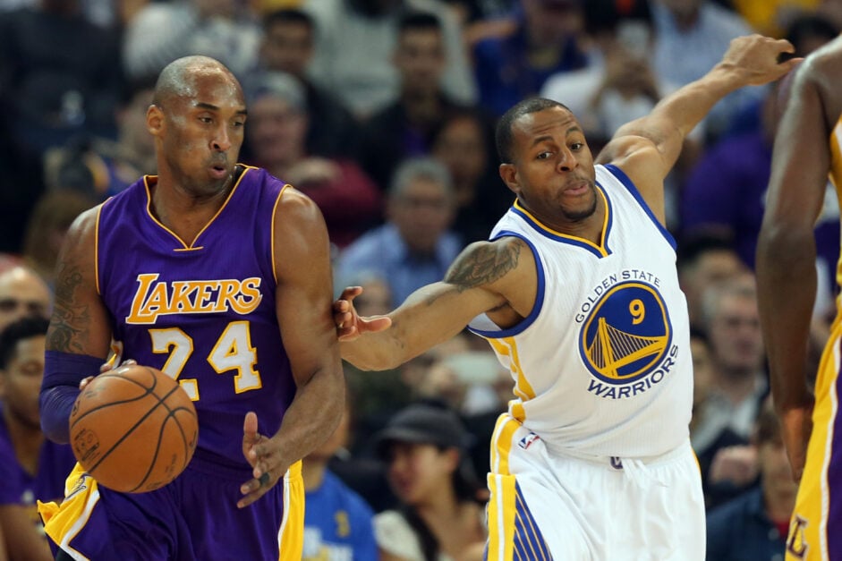 Los Angeles Lakers' Kobe Bryant (24) drives past Golden State Warriors' Andre Iguodala (9) in the first half of an NBA game at Oracle Arena.