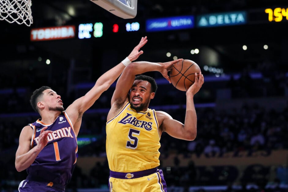 Talen Horton-Tucker of the Los Angeles Lakers drives to the basket defended by Devin Booker