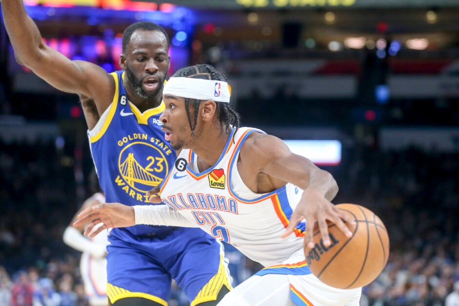 Shai Gilgeous-Alexander #2 of the Oklahoma City Thunder drives past Draymond Green #23 of the Golden State Warriors during the first quarter at Paycom Center on January 30, 2023 in Oklahoma City, Oklahoma.