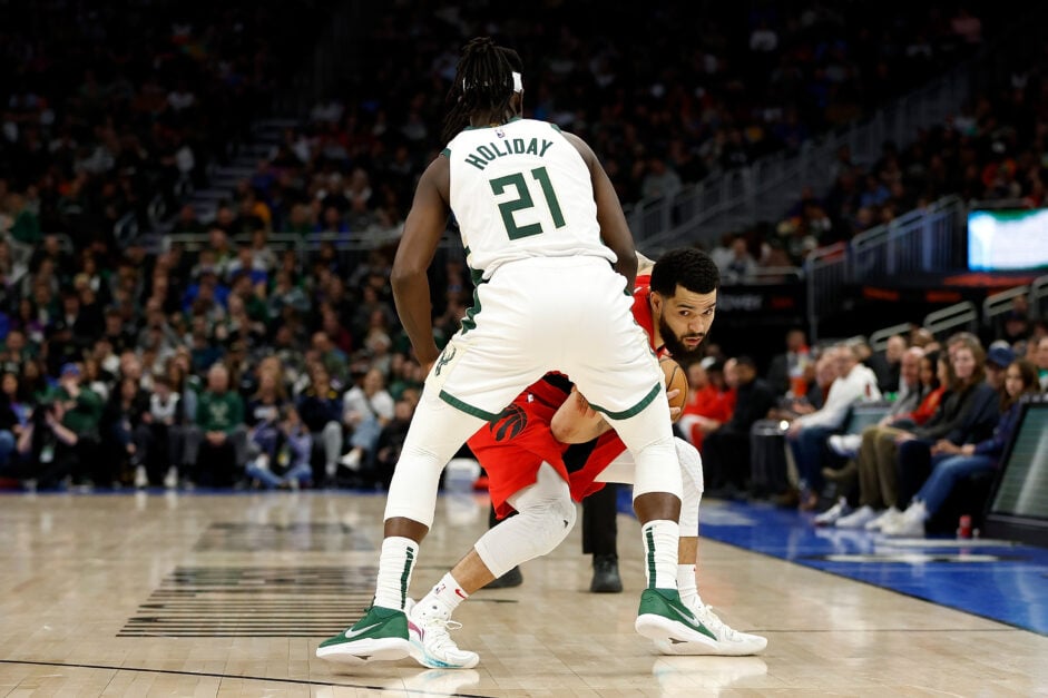 Fred VanVleet #23 of the Toronto Raptors looks to dribble while being guarded by Jrue Holiday #21 of the Milwaukee Bucks during the second half of the game at Fiserv Forum on March 19, 2023 in Milwaukee, Wisconsin.