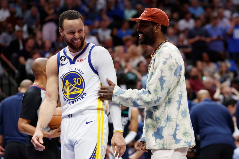 Stephen Curry #30 of the Golden State Warriors talks to Kyrie Irving of the Dallas Mavericks during a time out in the second half at American Airlines Center.