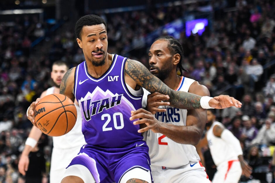 John Collins #20 of the Utah Jazz drives into Kawhi Leonard #2 of the LA Clippers during the first half of a game at Delta Center on December 08, 2023 in Salt Lake City, Utah.