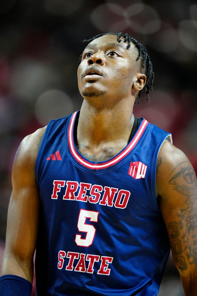 Fresno State basketball player #5 looking up.