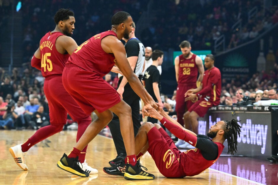 31: Donovan Mitchell #45 (C) and Evan Mobley #4 (C) help Darius Garland #10 of the Cleveland Cavaliers off the court during the first quarter against the Detroit Pistons.