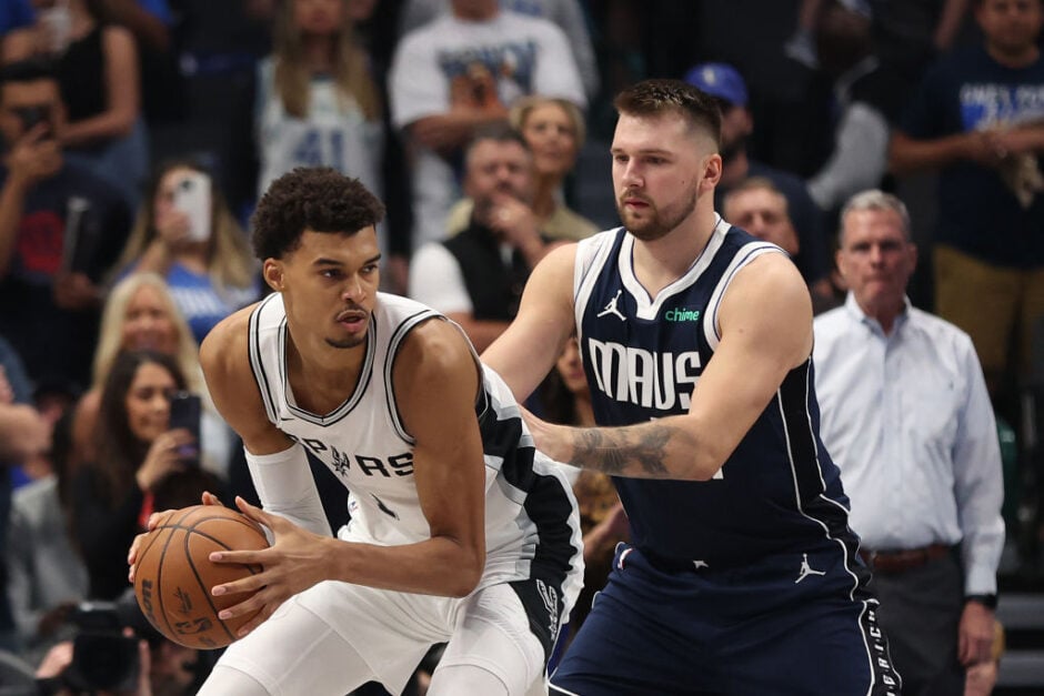 Victor Wembanyama #1 of the San Antonio Spurs is defended by Luka Doncic #77 of the Dallas Mavericks during the first quarter of the game at American Airlines Center.