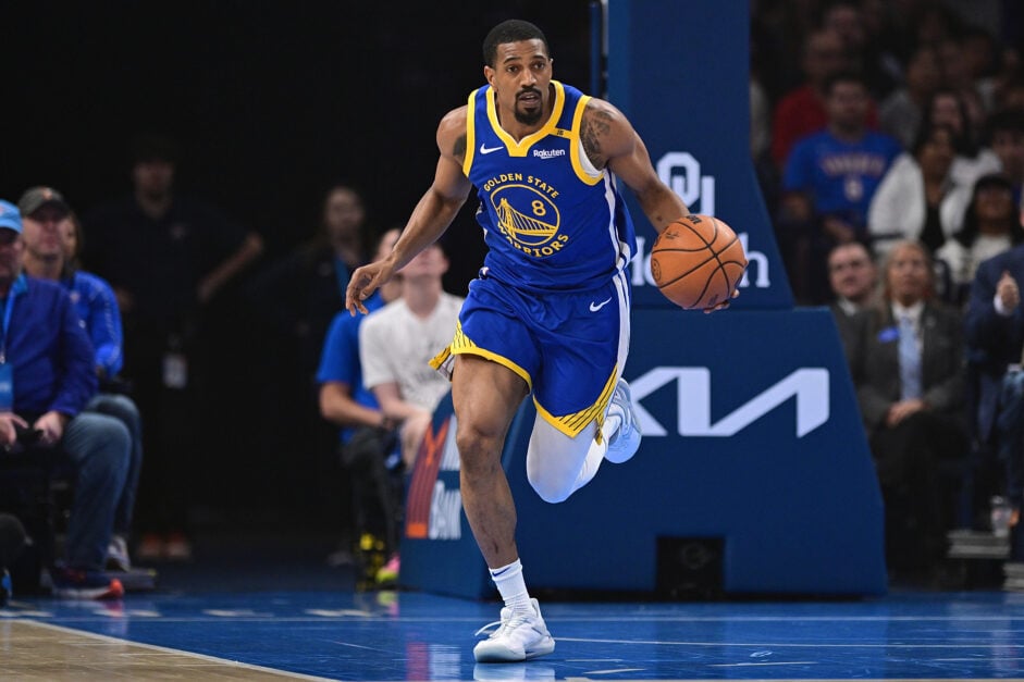 De'Anthony Melton in blue Golden State Warriors uniform, dribbling the ball during a game