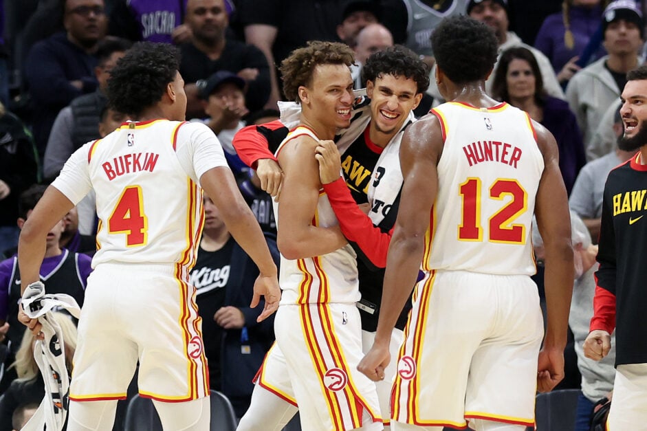 Dyson Daniels #5 of the Atlanta Hawks is congratulated by teammates after he striped the ball from De'Aaron Fox #5 of the Sacramento Kings at the end of the game at Golden 1 Center on November 18, 2024