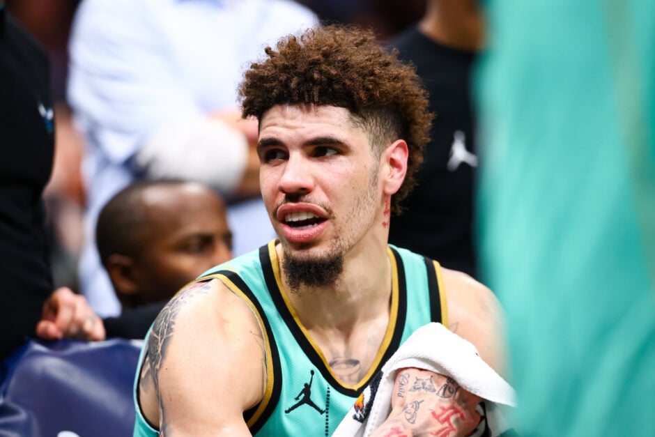 LaMelo Ball #1 of the Charlotte Hornets looks on from the bench during the second half of a basketball game against the Milwaukee Bucks at Spectrum Center.