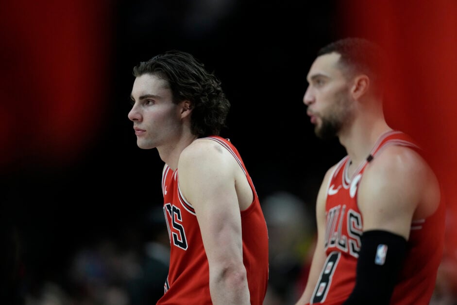 Josh Giddey (L) #3 and Zach LaVine #8 of the Chicago Bulls wait to enter the game at the scorers table during the second half against the Portland Trail Blazers at Moda Center.
