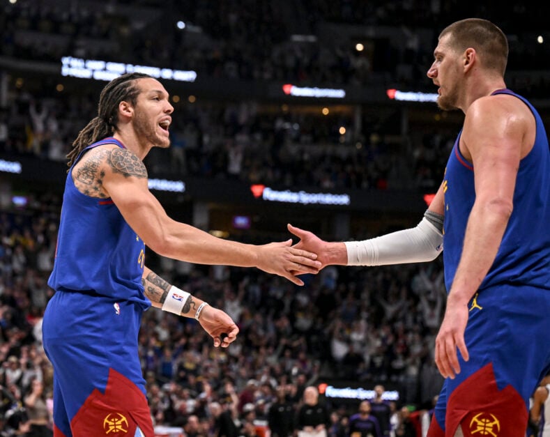 Aaron Gordon (32) greets Nikola Jokic (15) of the Denver Nuggets after Jokic hit a full-court heave against the Sacramento Kings during the third quarter at Ball Arena.