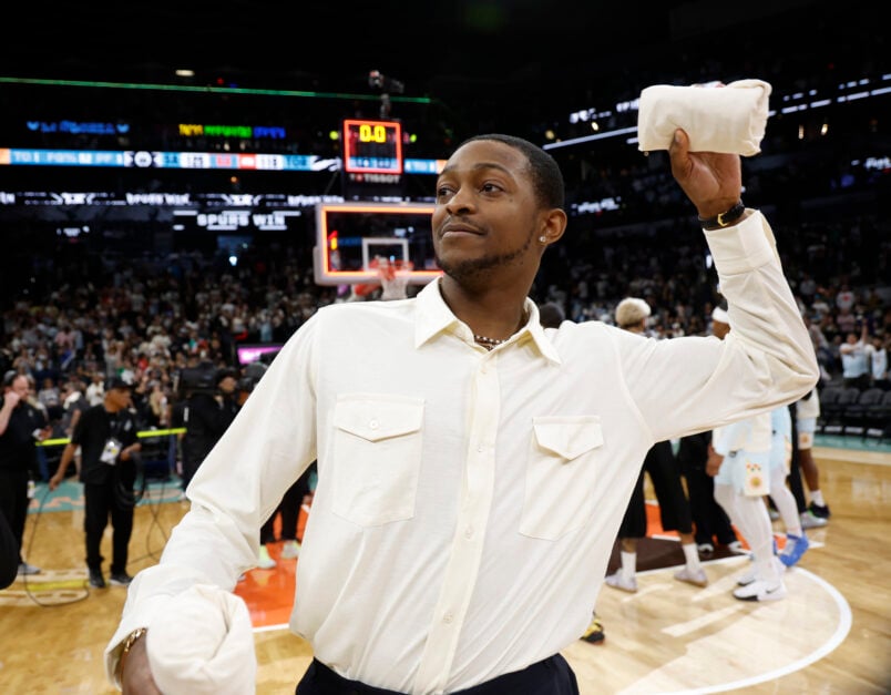 De'Aaron Fox #4 of the San Antonio Spurs throws t-shirts to fans at the end of the game against Toronto Raptors as part of Fans Appreciation.