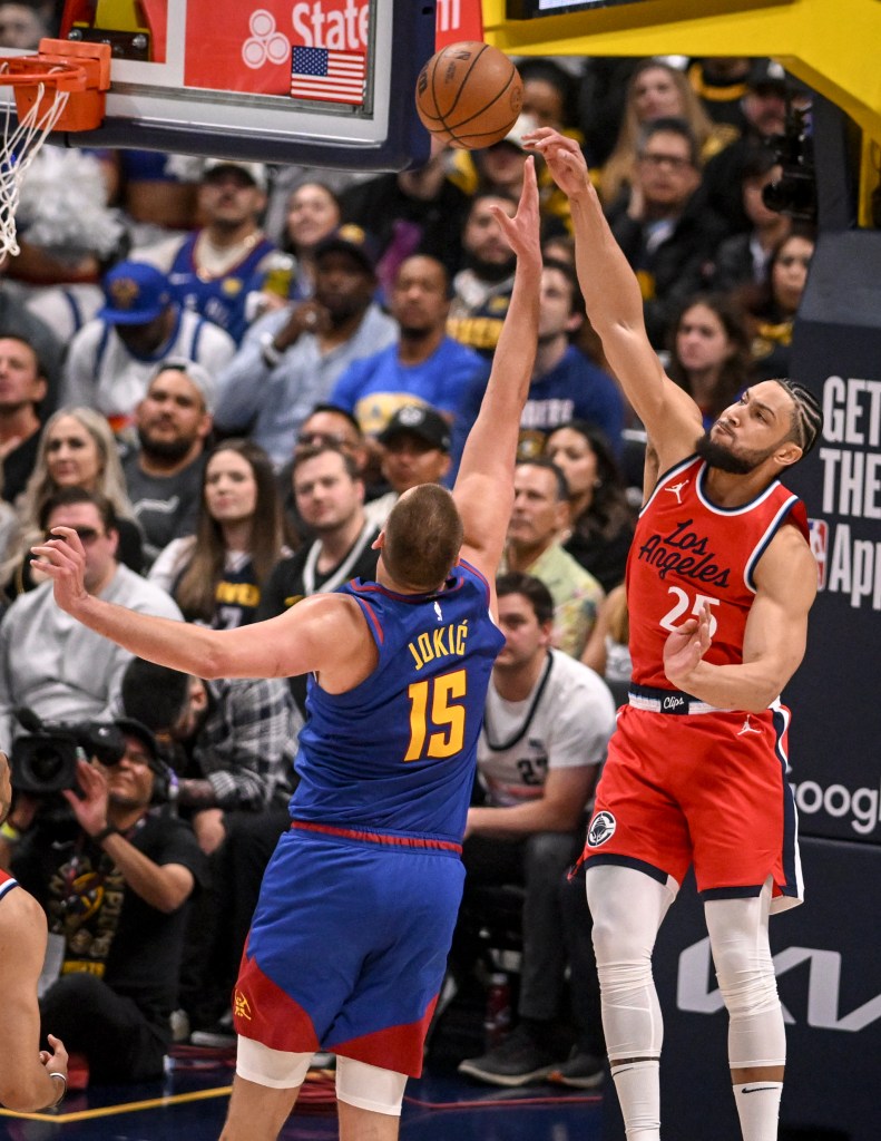 Ben Simmons (25) has a rebound tipped away by Nuggets star Nikola Jokic (15).