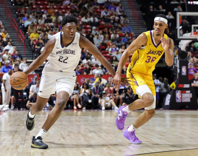 Derik Queen #22 of the New Orleans Pelicans drives against Darius Bazley #36 of the Los Angeles Lakers in the first half of a 2025 NBA Summer League game.