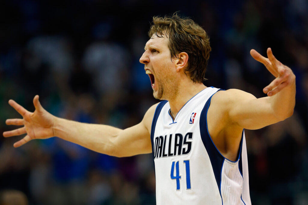 Dirk Nowitzki #41 of the Dallas Mavericks reacts after making a three point shot