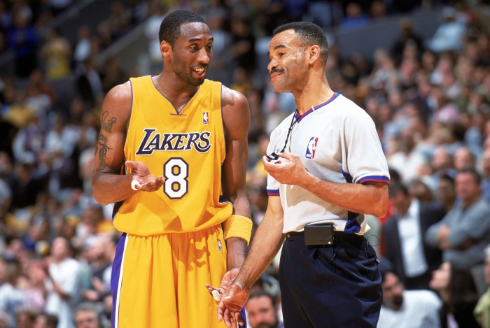 Kobe Bryant talks with official Danny Crawford during a game.