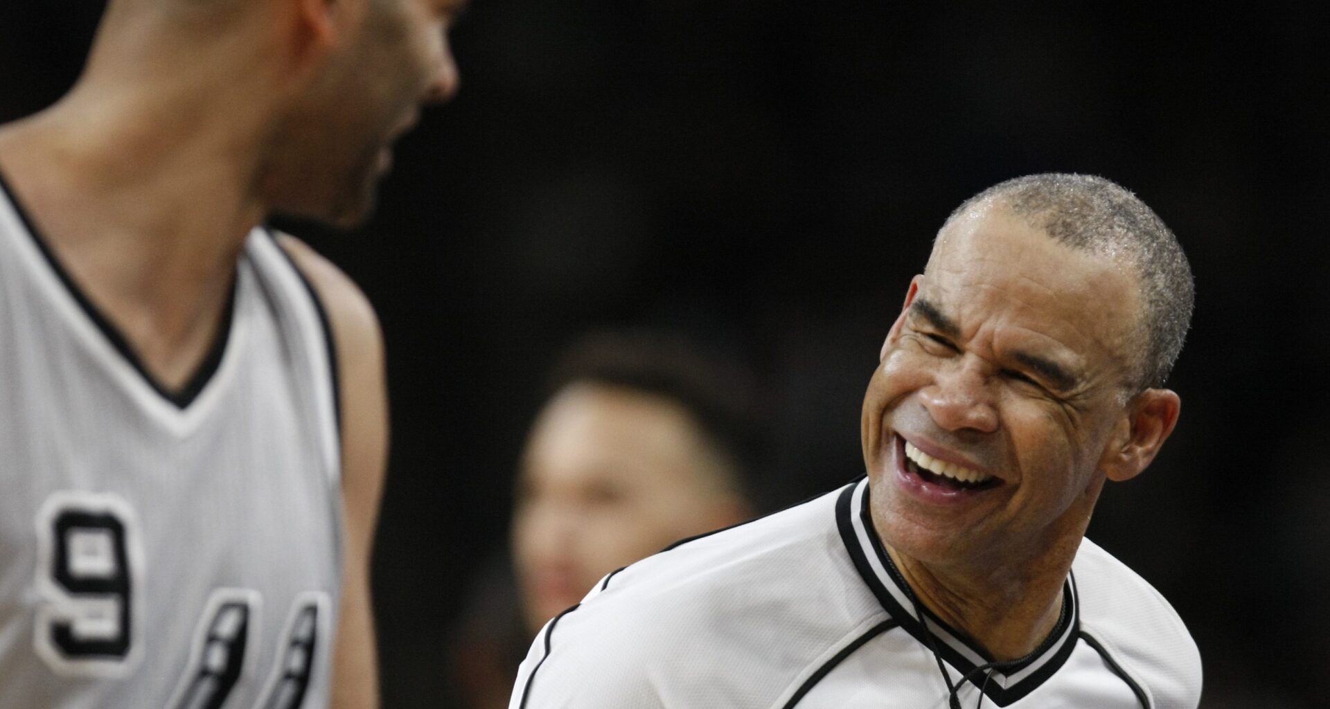 Referee Danny Crawford laughs with a player during a game