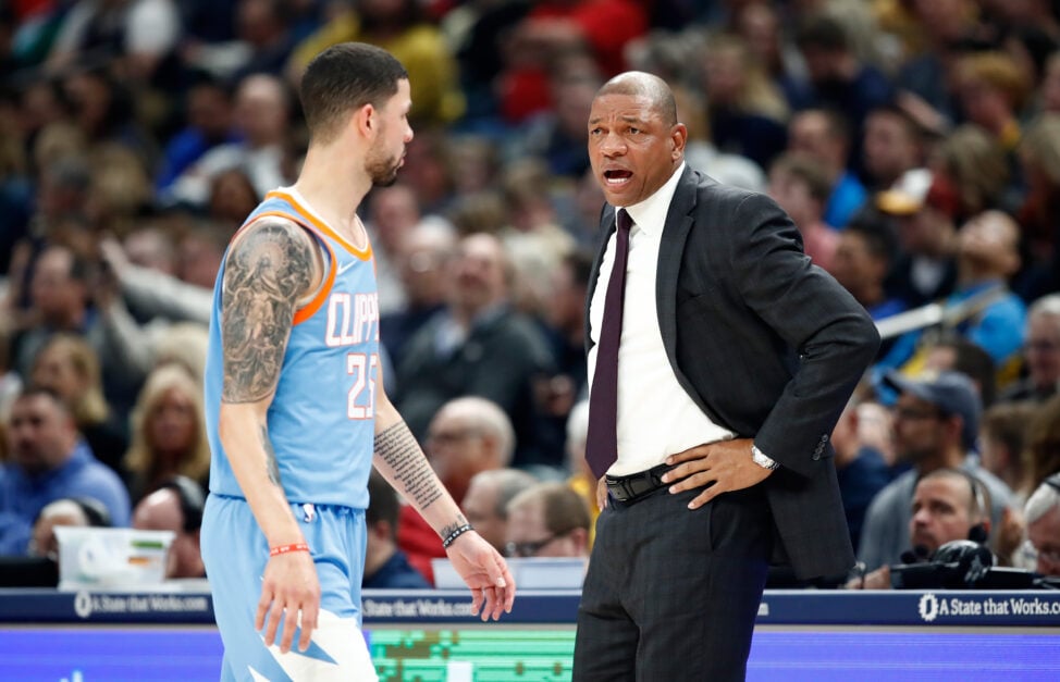 Doc Rivers the head coach of the Los Angeles Clippers gives instructions to Austin Rivers #25 against the Indiana Pacers at Bankers Life Fieldhouse.