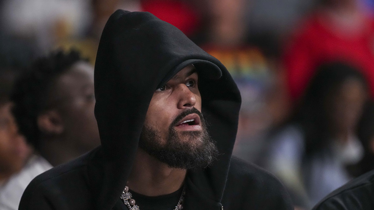 Hawks player Trae Young watches the game between the Atlanta Dream against the Minnesota Lynx during the first half at Gateway Center Arena at College Park
