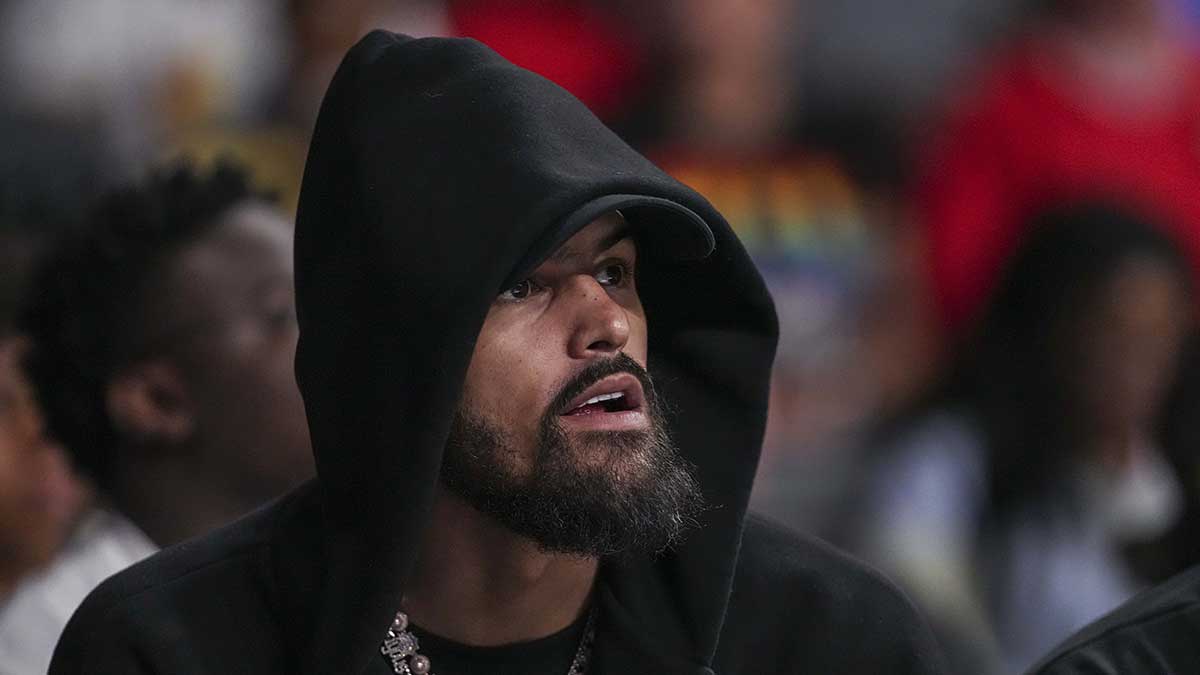 Hawks player Trae Young watches the game between the Atlanta Dream against the Minnesota Lynx during the first half at Gateway Center Arena at College Park