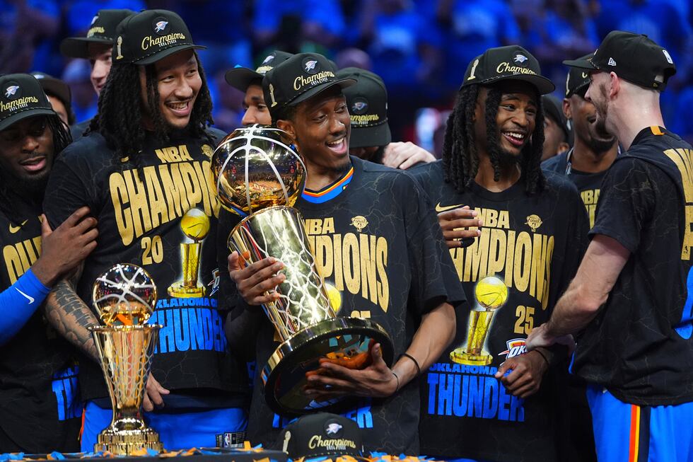 Oklahoma City Thunder forward Jalen Williams (8) holds the Larry O'Brien Championship Trophy...