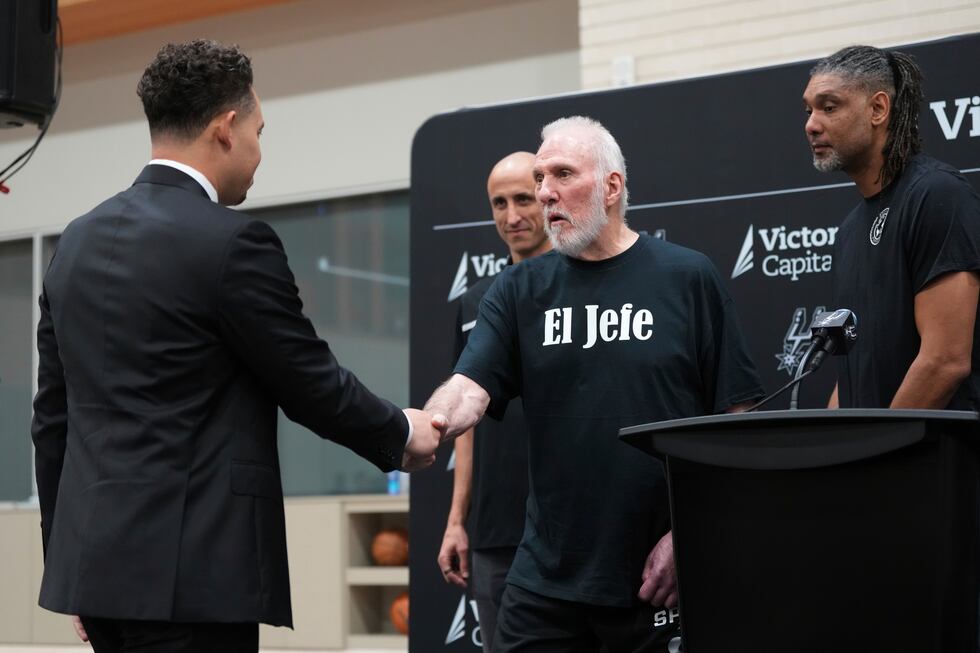 With the help of former players Manu Ginobili, back left, and Tim Duncan, right, former San...