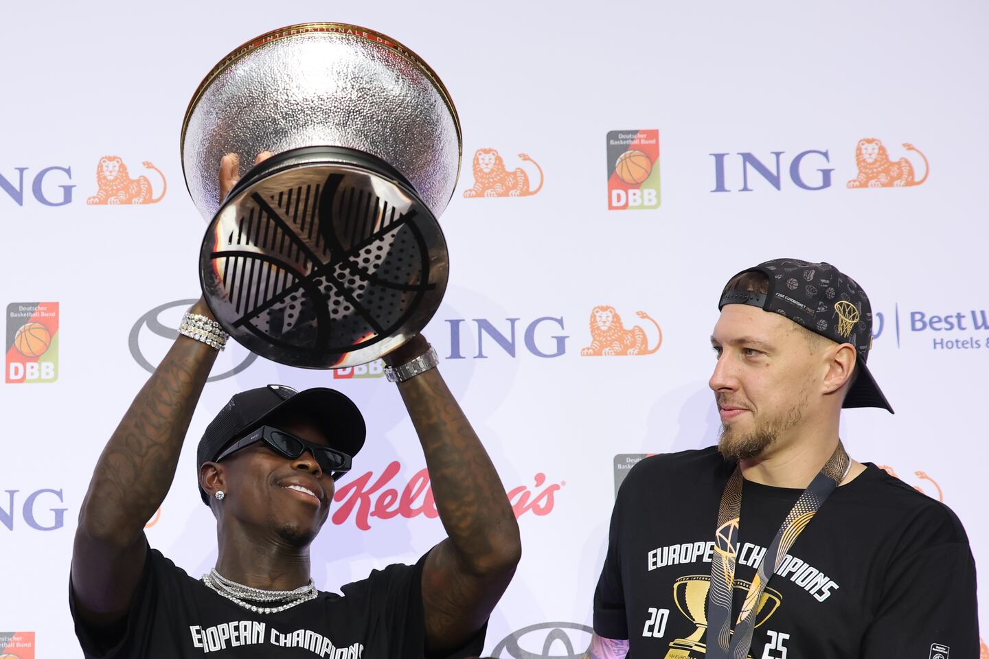 Dennis Schröder and Daniel Theis, both former Celtics, celebrated with the FIBA EuroBasket 2025 trophy.