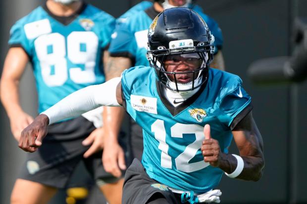 Jacksonville Jaguars wide receiver Travis Hunter (12) runs through a drill during practice at the team's NFL football training camp, Wednesday, July 23, 2025, in Jacksonville, Fla. (AP Photo/John Raoux)