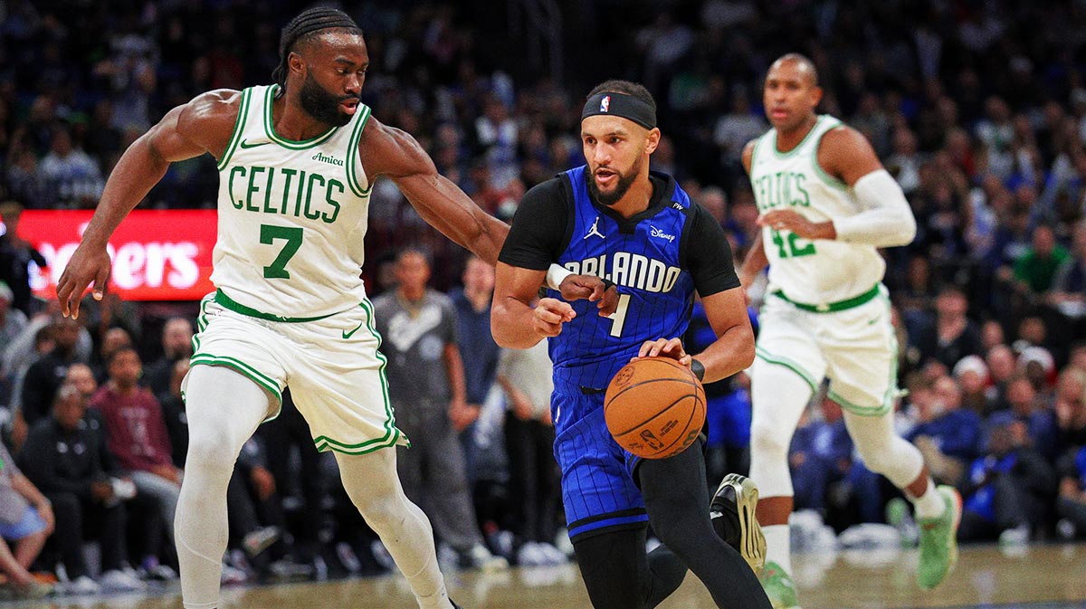 Orlando Magic guard Jalen Suggs (4) drives to the basket past Boston Celtics guard Jaylen Brown (7) in the third quarter at Kia Center.