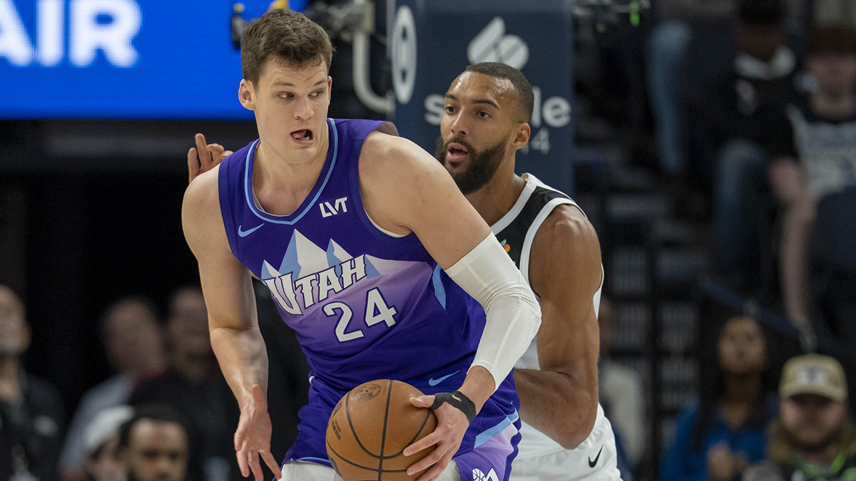 Jazz center Walker Kessler (24) backs towards the basket as Minnesota Timberwolves center Rudy Gobert (27) plays defense in the first half at Target Center