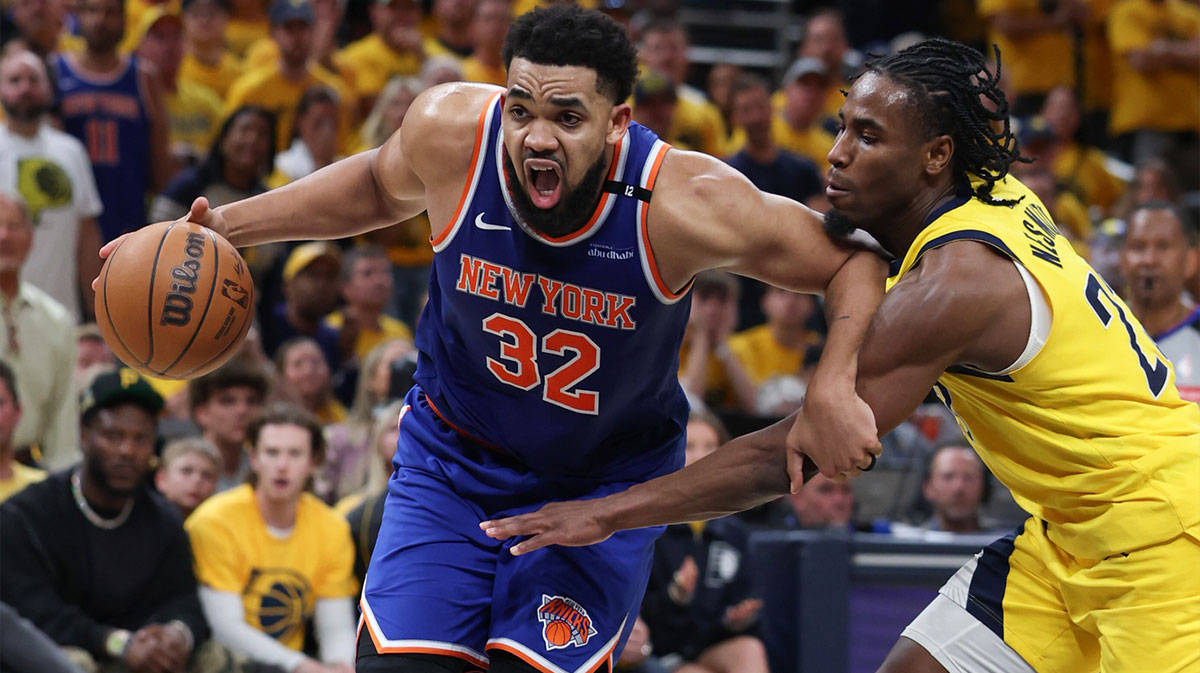 New York Knicks center Karl-Anthony Towns (32) drives to the basket against Indiana Pacers guard Andrew Nembhard (2) in the third quarter during game six of the eastern conference finals for the 2025 NBA Playoffs at Gainbridge Fieldhouse.