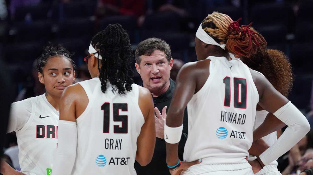 Atlanta Dream head coach Karl Smesko talks with Atlanta Dream guard Te-Hina Paopao (2), guard Allisha Gray (15), guard Rhyne Howard (10) and the team during a timeout against the Golden State Valkyries in the third quarter at Chase Center.