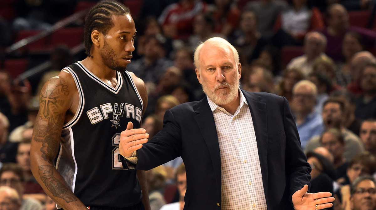 San Antonio Spurs head coach Gregg Popovich speaks with San Antonio Spurs forward Kawhi Leonard (2) during the fourth quarter of the game against the Portland Trail Blazers at the Moda Center at the Rose Quarter.