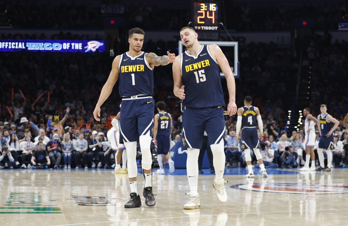 Denver Nuggets forward Michael Porter Jr. (1) and center Nikola Jokic (15) talk during a time out against the Oklahoma City Thunder during the second half at Paycom Center.