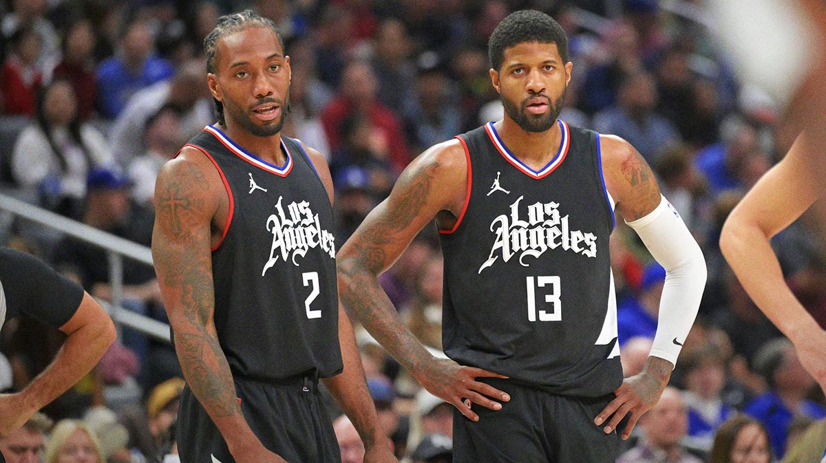 Los Angeles Clippers forward Kawhi Leonard (2) and forward Paul George (13) look on in the second half against the Detroit Pistons at Crypto.com Arena.